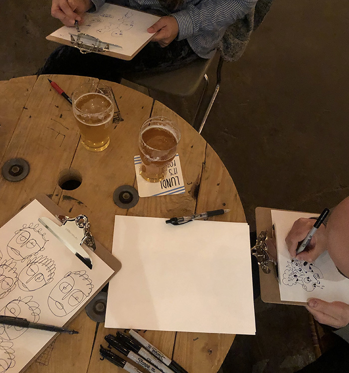 people drawing at a table
