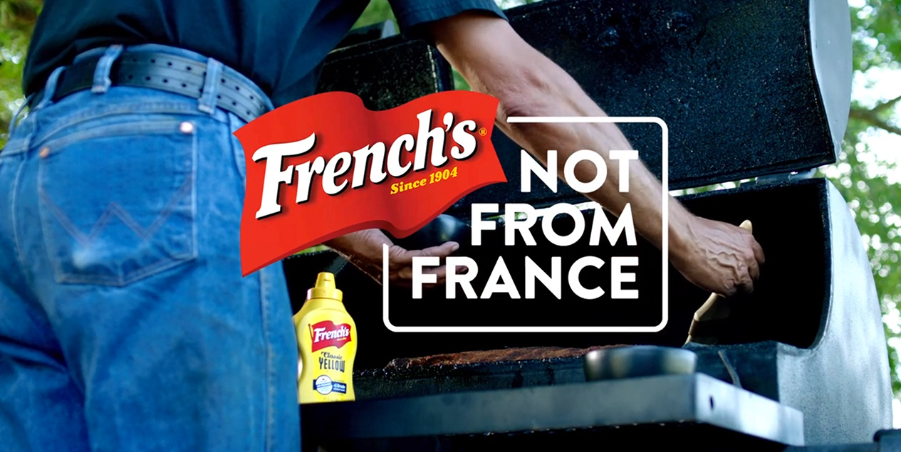 Man grilling behind French's logo