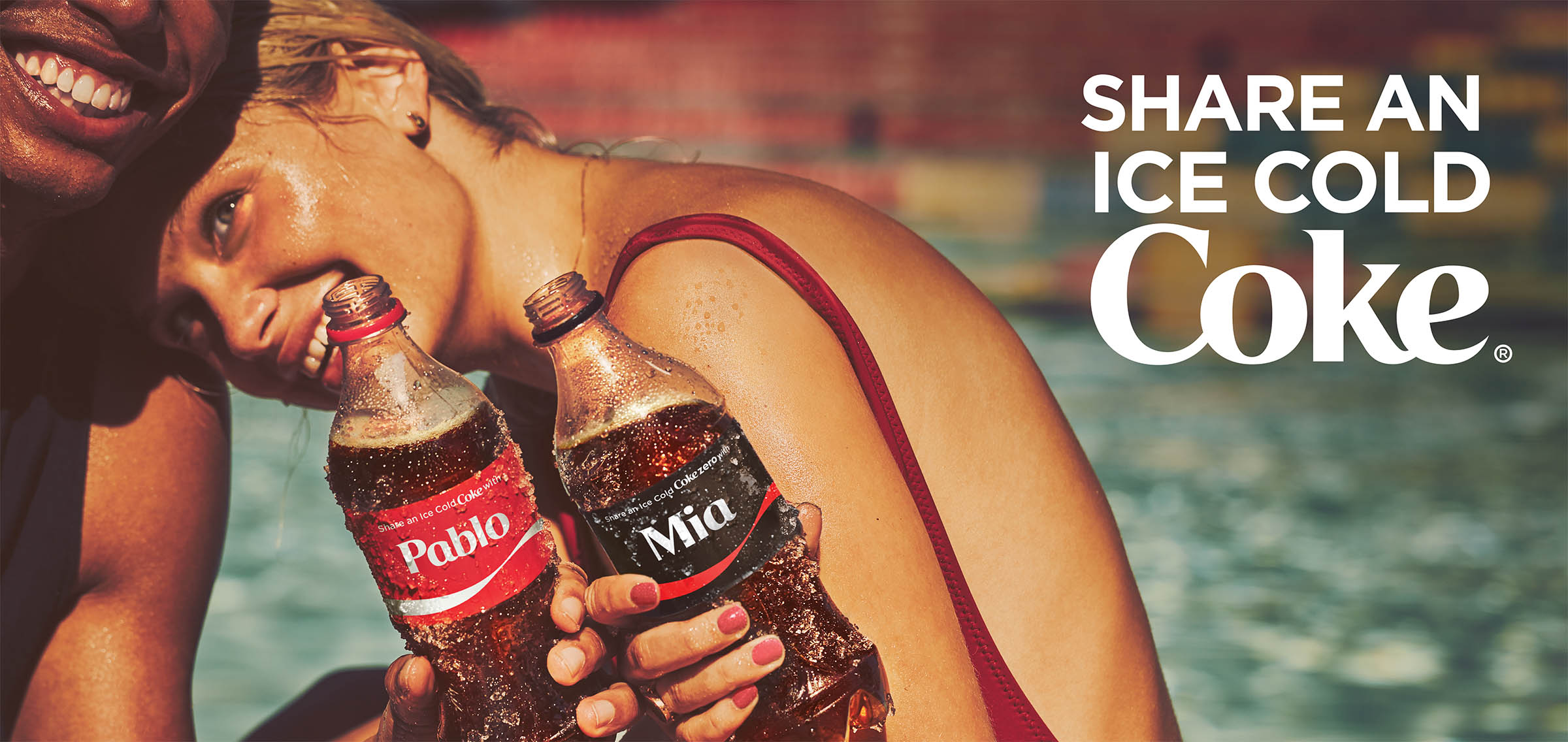 Billboard of teens with Coca-Cola. Says "Share an ice cold Coke".